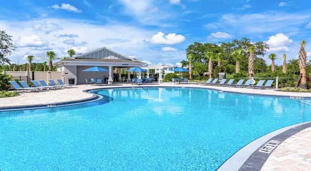 a view of a swimming pool with outdoor seating and city view