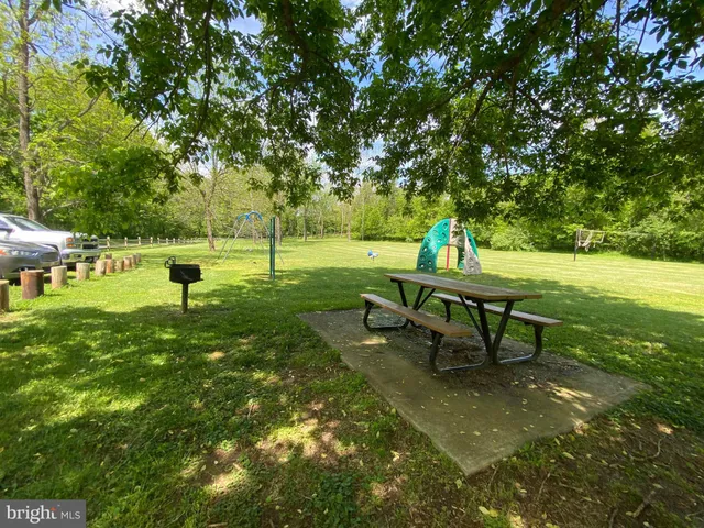 a view of a swimming pool with a patio and a yard