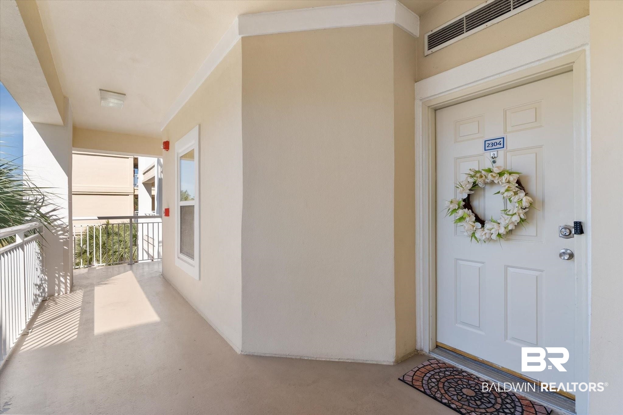 27770 Canal Road, Unit 2304 Orange Beach, AL 36561 - Photo 4 of 30 View of exterior entry featuring a balcony, visible vents, and stucco siding