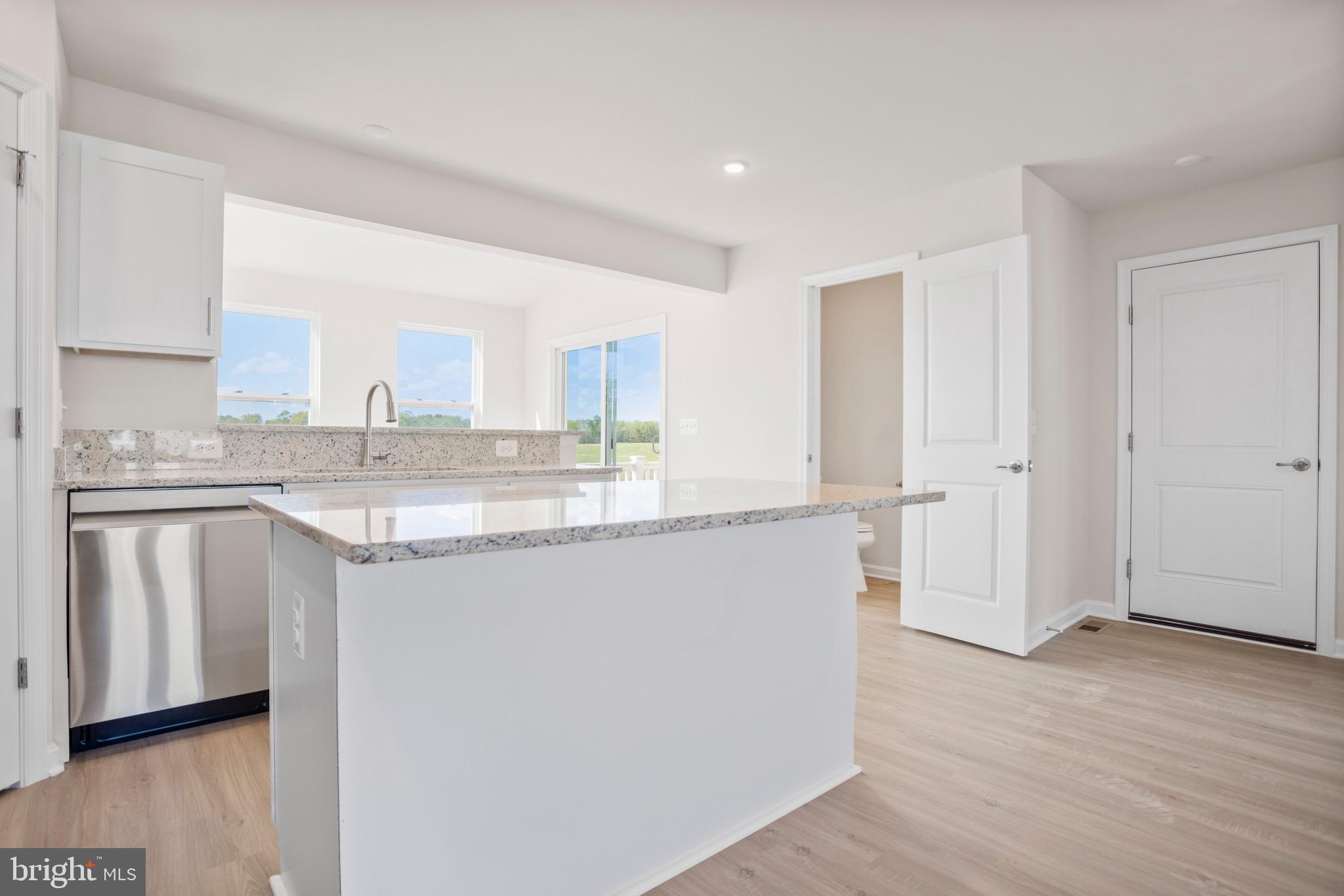 0 Grayling Road Inwood, WV 25428 - Photo 6 of 24 a kitchen with granite countertop white cabinets and white appliances
