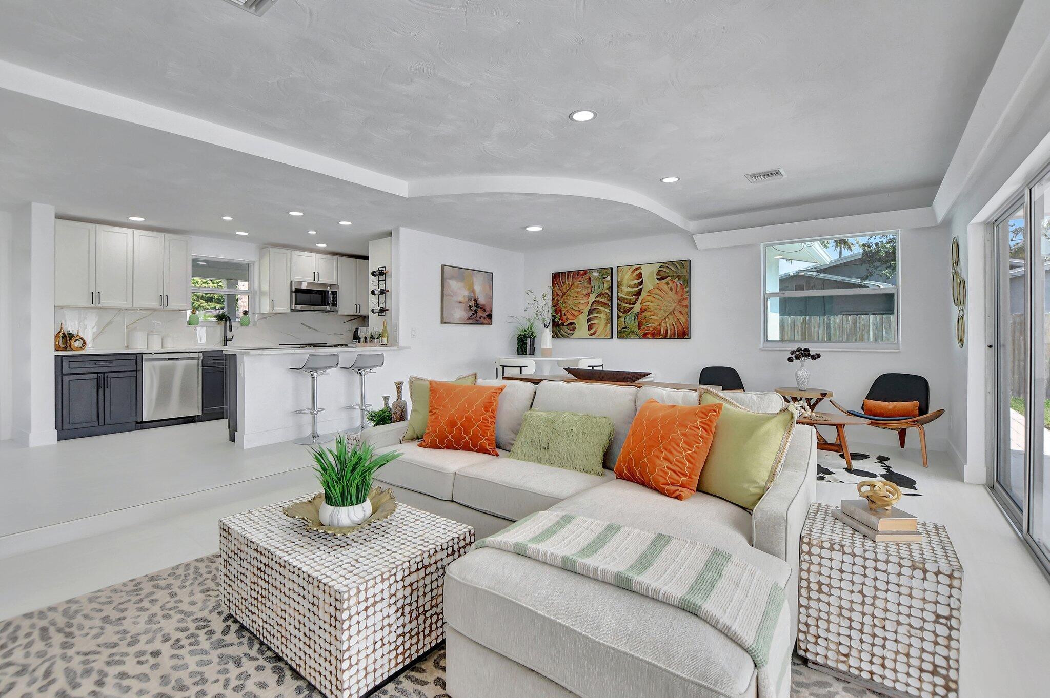 832 Southwest 10th Avenue Boca Raton, FL 33486 - Photo 16 of 57 a living room with furniture and a dining table with kitchen view