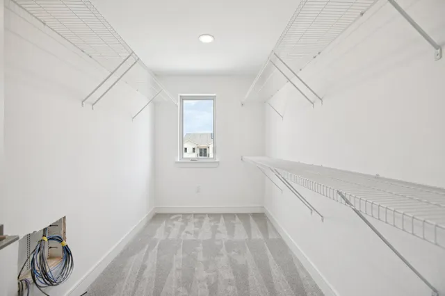 an empty room with a ceiling fan and window