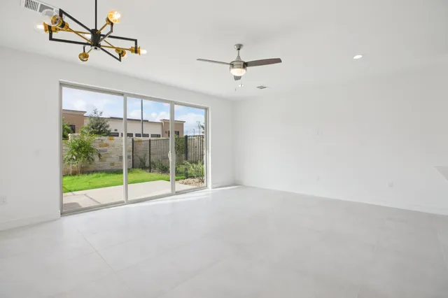 a view of room with window and ceiling fan