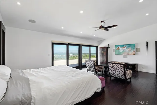 a bedroom with a bed mirror and window