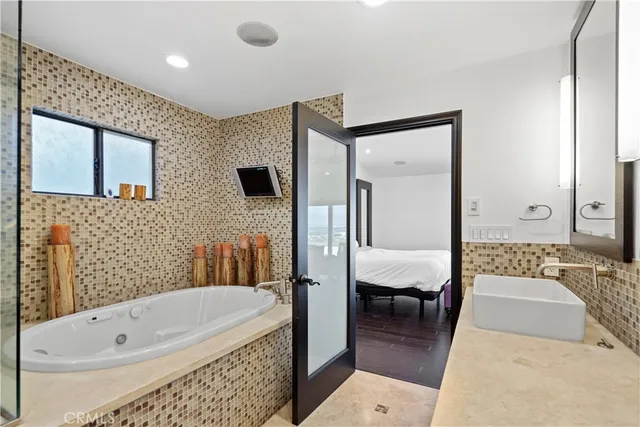a bathroom with a tub a sink and a rug