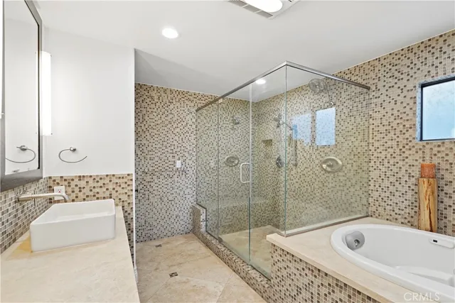 a bathroom with a bathtub and a shower