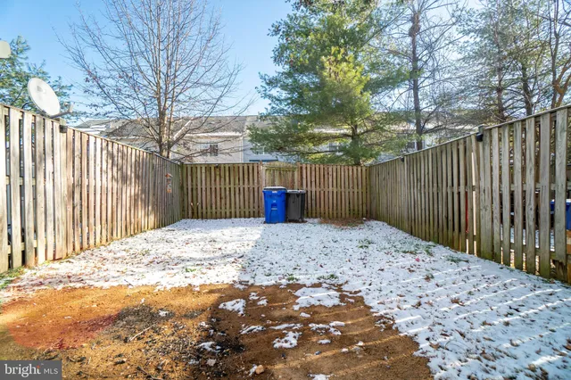 a backyard of a house with wooden fence
