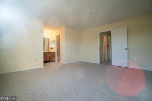 an empty room with windows and cabinet