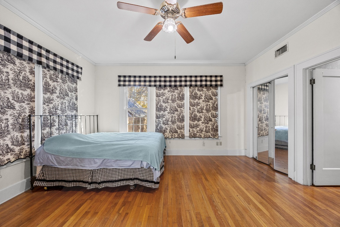 1006 Maple Street Lockhart, TX 78644 - Photo 12 of 32 Bedroom with ornamental molding, a ceiling fan, and wood-type flooring