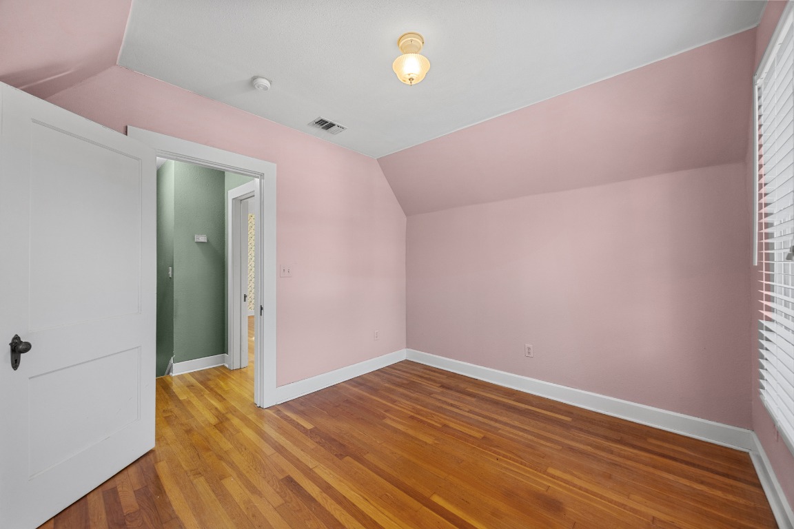 1006 Maple Street Lockhart, TX 78644 - Photo 16 of 32 Bonus room featuring lofted ceiling and hardwood / wood-style floors