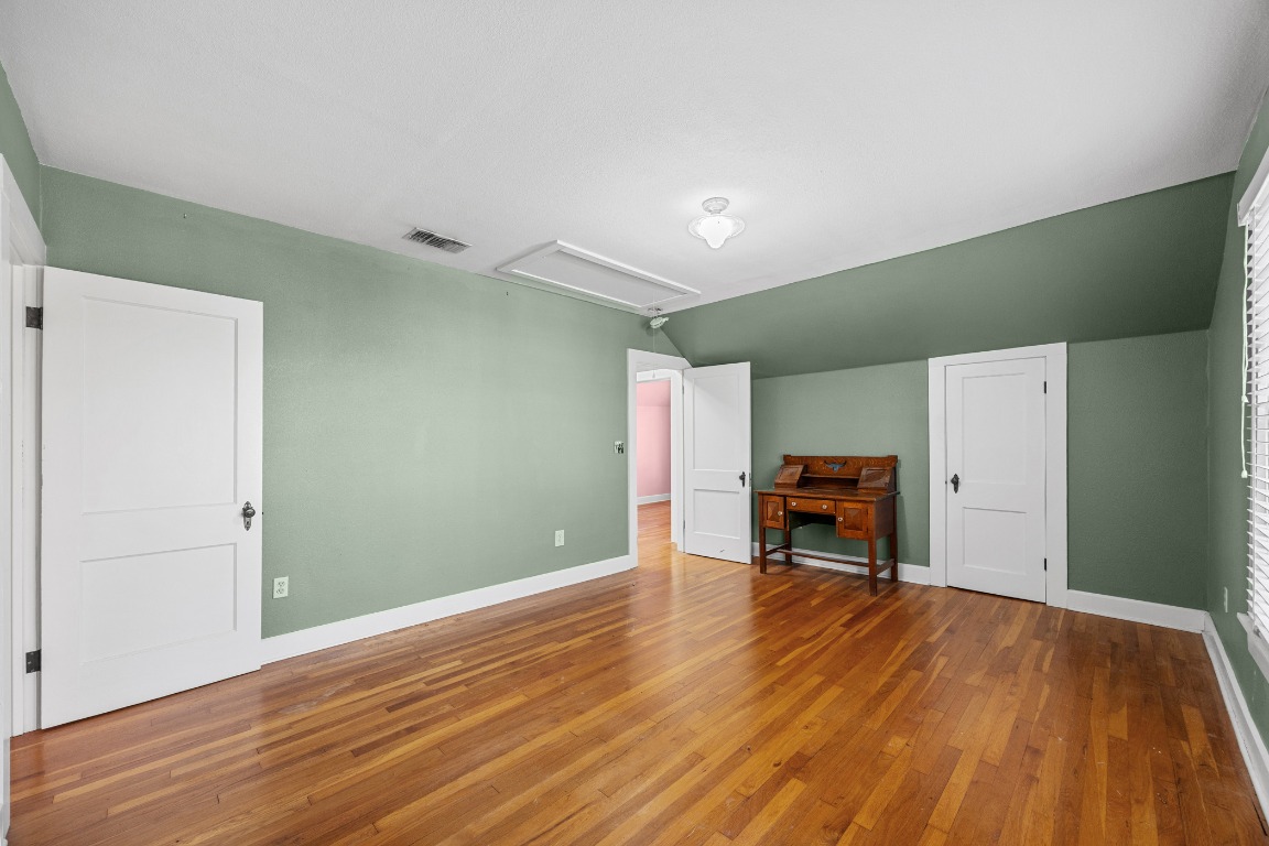 1006 Maple Street Lockhart, TX 78644 - Photo 22 of 32 Additional living space featuring attic access, hardwood / wood-style floors, and lofted ceiling