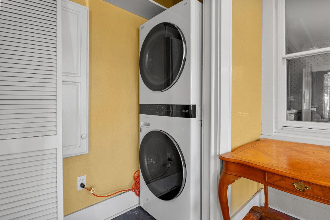 1006 Maple Street Lockhart, TX 78644 - Photo 25 of 32 Laundry room featuring stacked washer / dryer