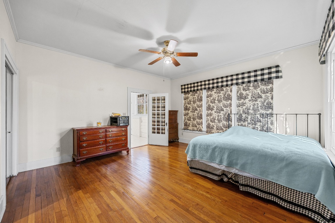 1006 Maple Street Lockhart, TX 78644 - Photo 10 of 32 Bedroom featuring ornamental molding, hardwood / wood-style floors, and ceiling fan