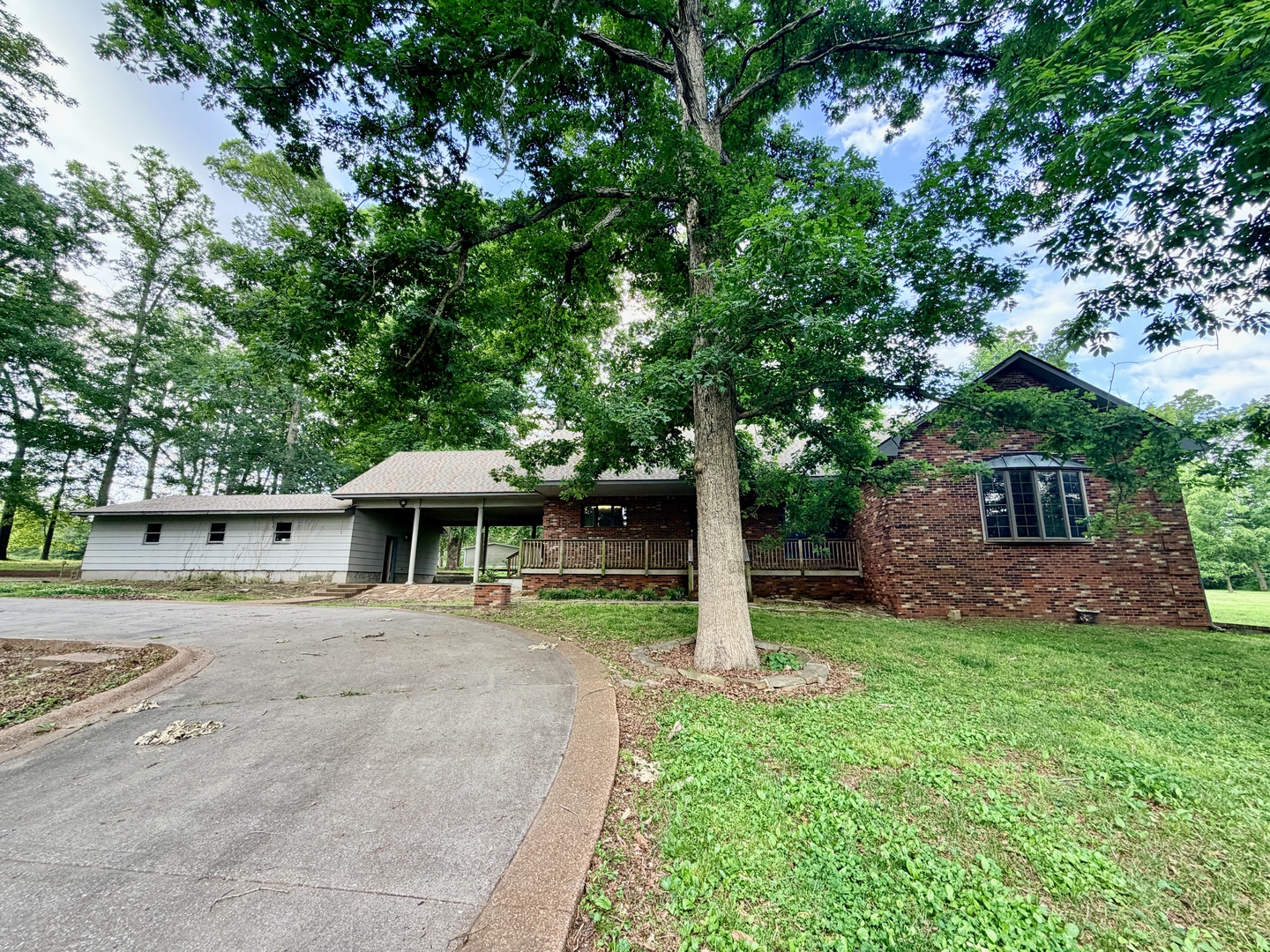 a view of a house with a yard and tree s