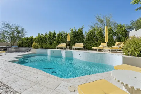 a view of a backyard with a small pool and stove