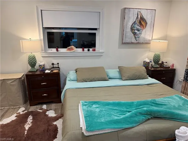 a bedroom with a bed and a television