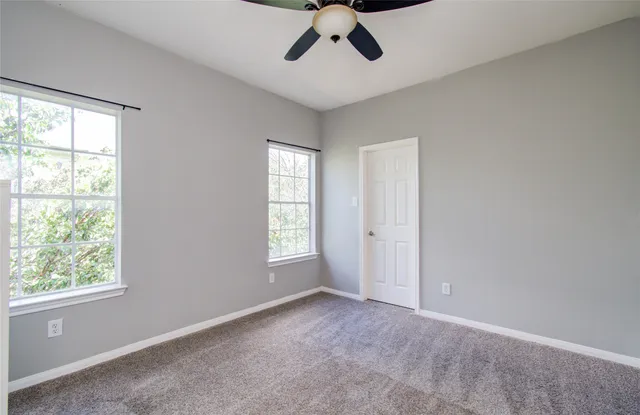 a view of a livingroom with a ceiling fan and window