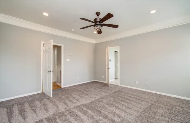 a view of an empty room with a ceiling fan