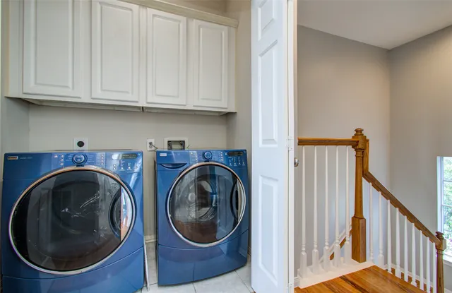 a view of a storage and utility room with washer and dryer