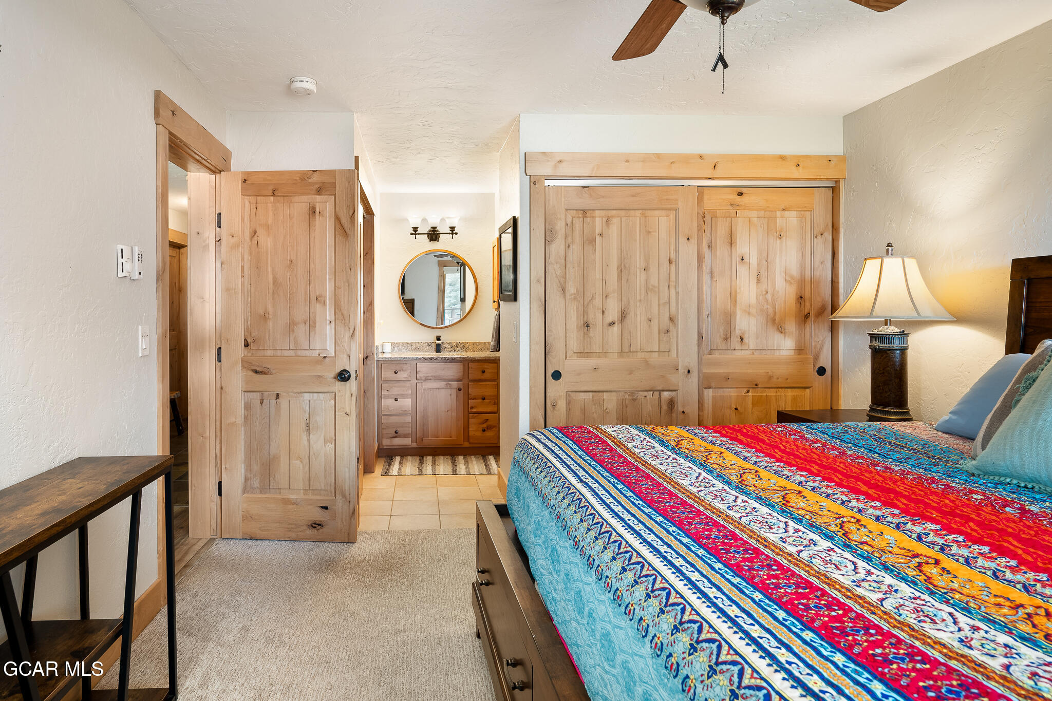 605 Lake Front Road, Unit W8 Grand Lake, CO 80447 - Photo 16 of 28 a room with a bed and a chandelier