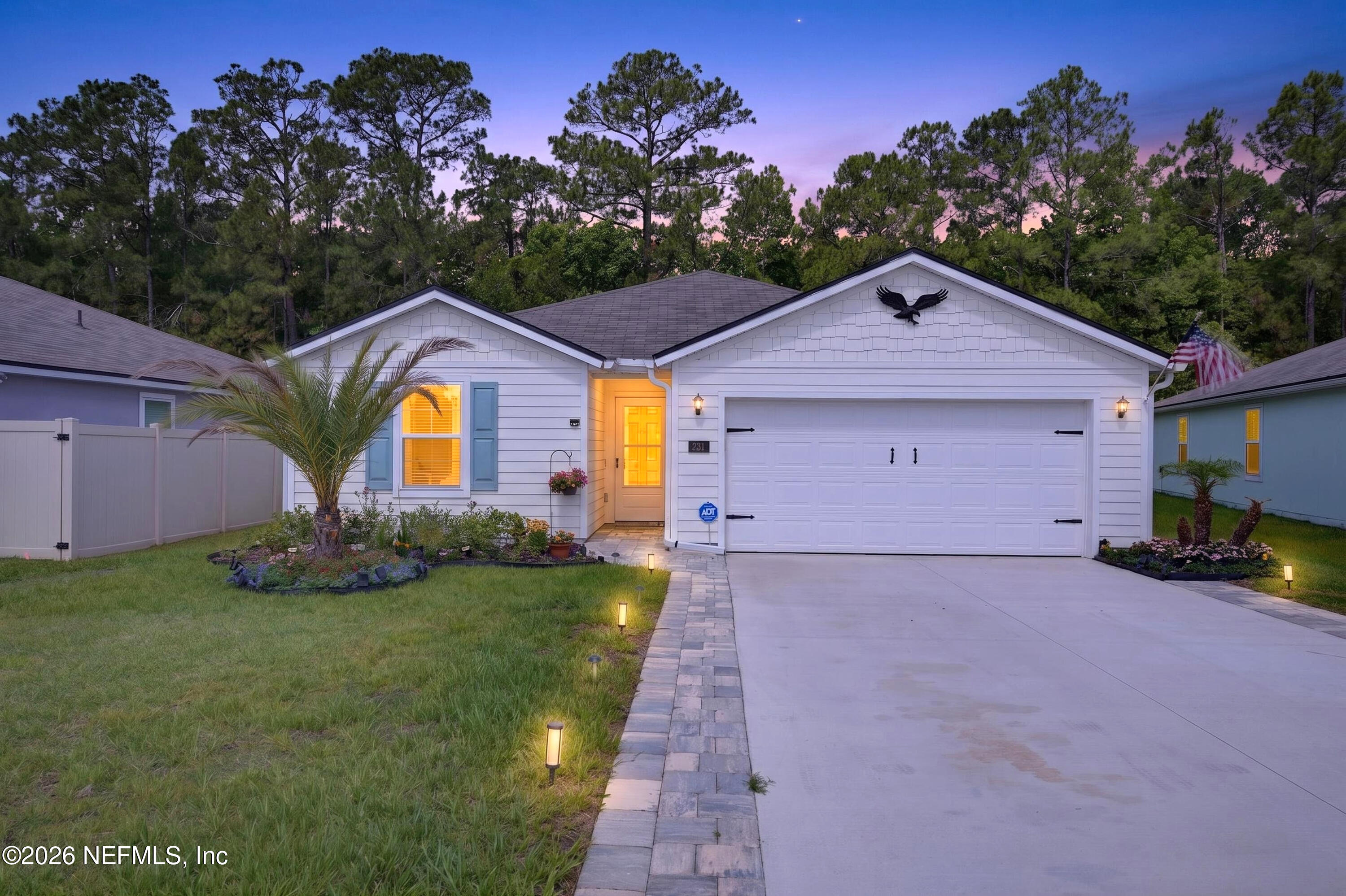 231 Encanto Way Street St. Augustine, FL 32084 - Photo 28 of 36 a front view of a house with a yard and garage