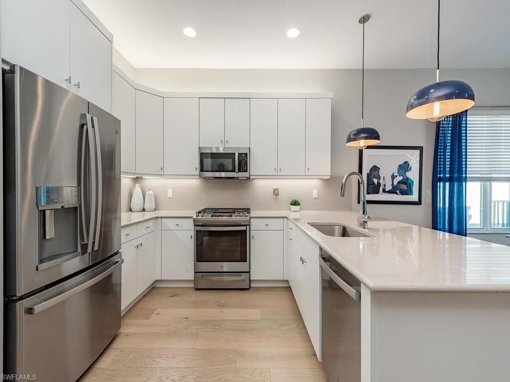 12456 Violet Lane Naples, FL 34120 - Photo 12 of 34 a kitchen with stainless steel appliances granite countertop a refrigerator a stove and a sink