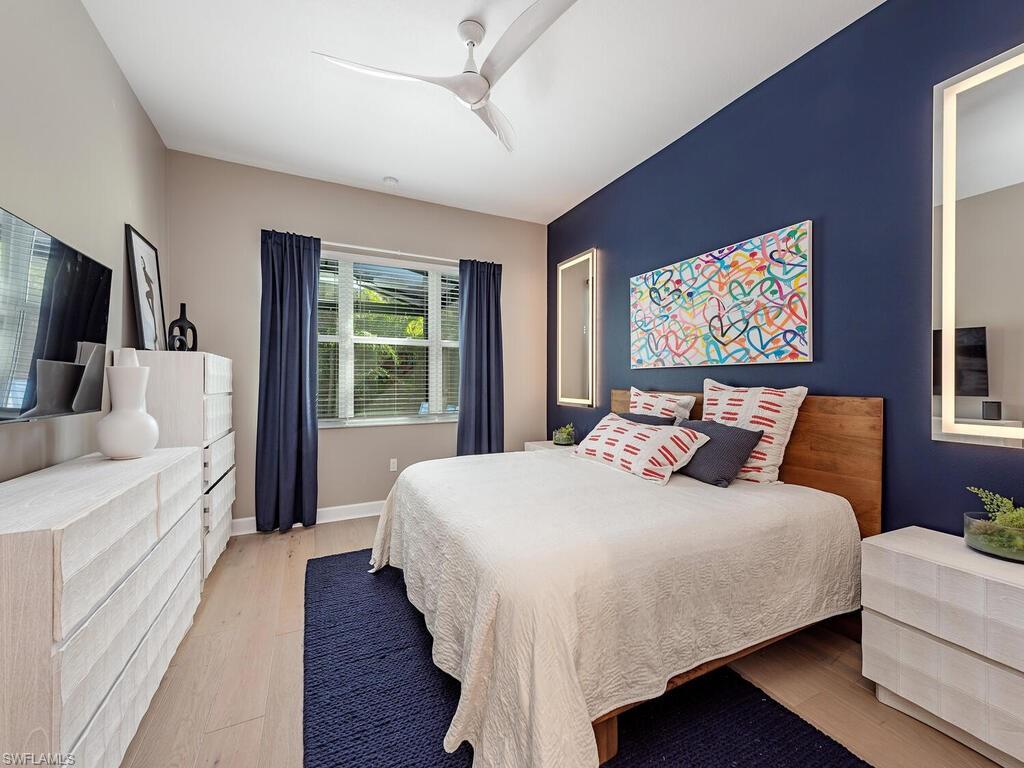 12456 Violet Lane Naples, FL 34120 - Photo 14 of 34 a bedroom with a bed and a flat screen tv