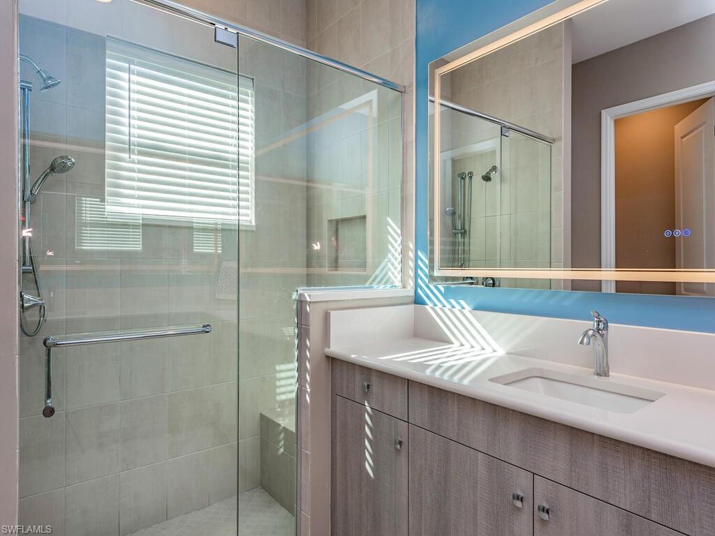 12456 Violet Lane Naples, FL 34120 - Photo 16 of 34 a bathroom with a sink and a mirror