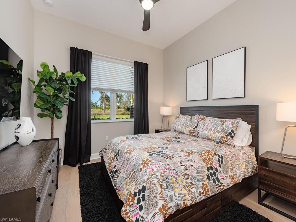 12456 Violet Lane Naples, FL 34120 - Photo 17 of 34 a bedroom with bed and a potted plant