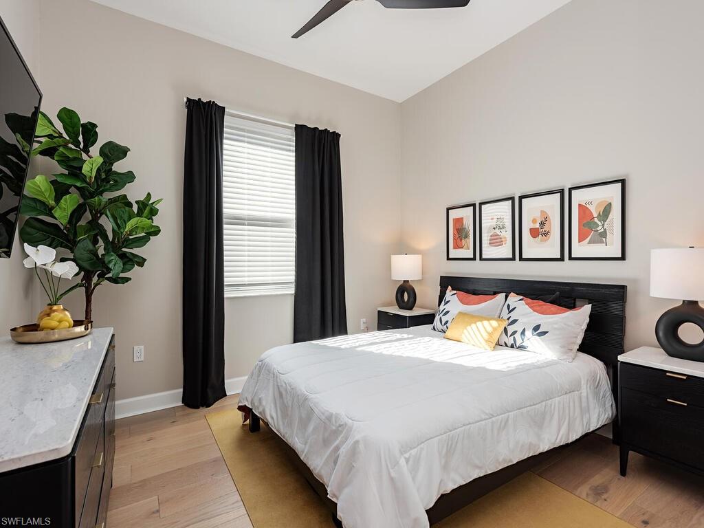 12456 Violet Lane Naples, FL 34120 - Photo 19 of 34 a bedroom with a bed and a potted plant