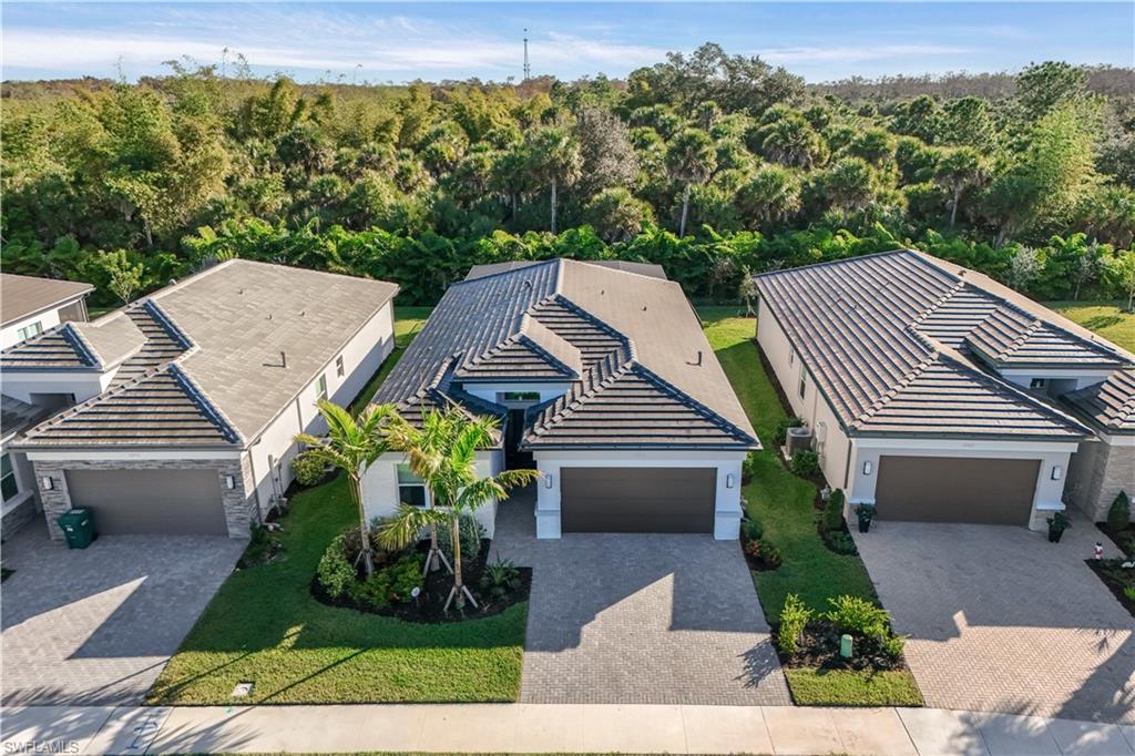 12456 Violet Lane Naples, FL 34120 - Photo 24 of 34 a view of a patio with two chairs and a table