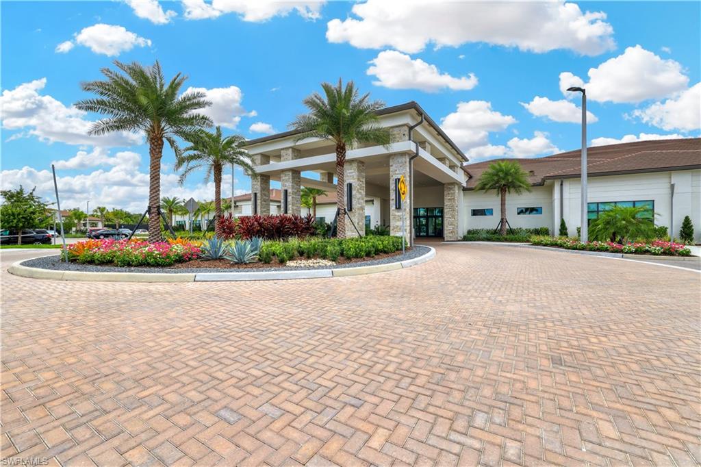 12456 Violet Lane Naples, FL 34120 - Photo 26 of 34 a front view of a building with a garden