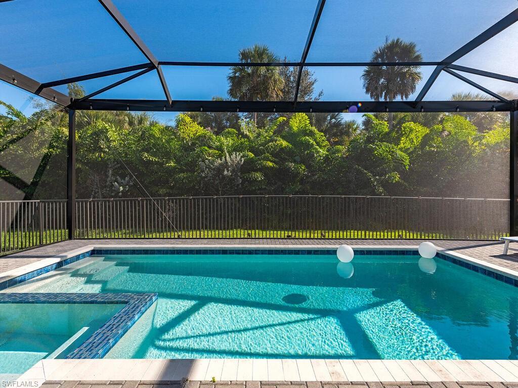 12456 Violet Lane Naples, FL 34120 - Photo 3 of 34 a view of swimming pool with outdoor space and seating area