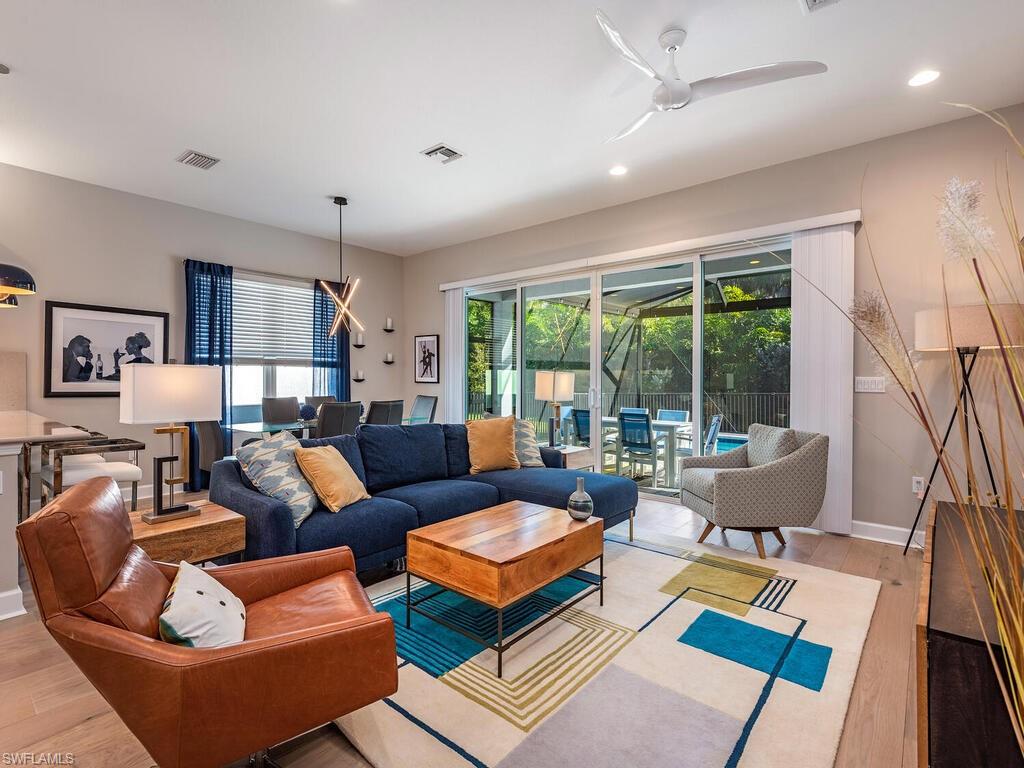 12456 Violet Lane Naples, FL 34120 - Photo 7 of 34 a living room with furniture and large windows