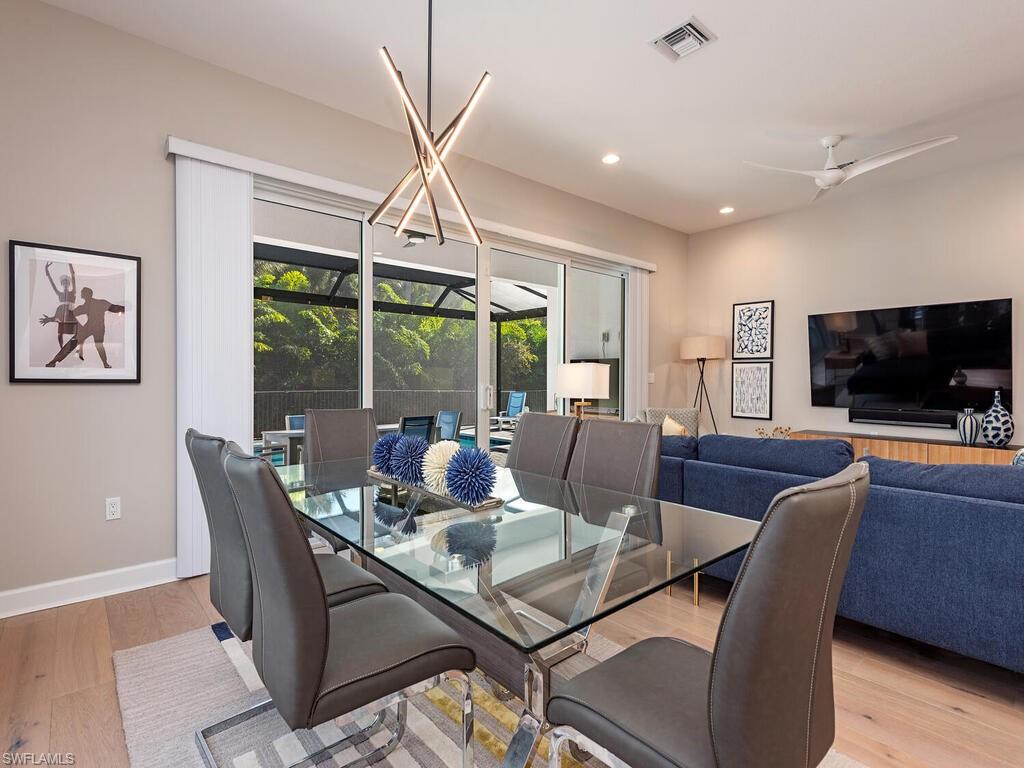 12456 Violet Lane Naples, FL 34120 - Photo 9 of 34 a view of a dining room with furniture window and wooden floor