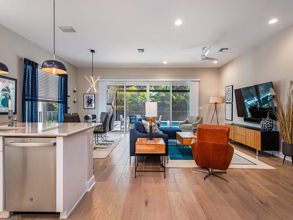 12456 Violet Lane Naples, FL 34120 - Photo 10 of 34 a living room with furniture and a flat screen tv