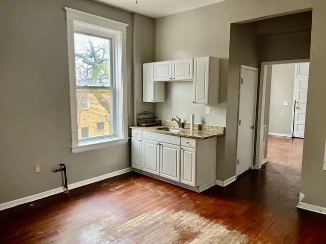 a kitchen with a refrigerator and window