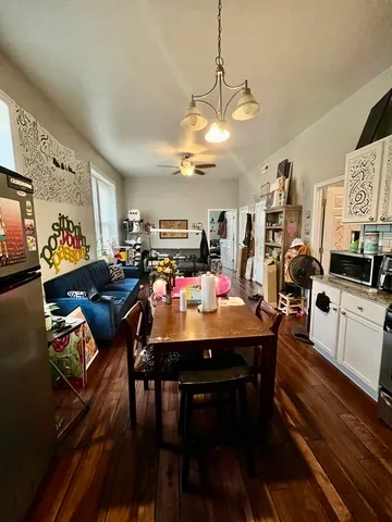 a view of a dining room with furniture and a chandelier
