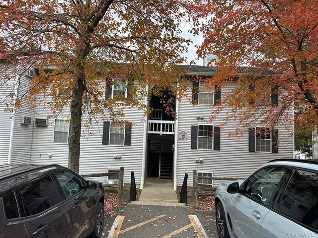 a front view of a house with parking space