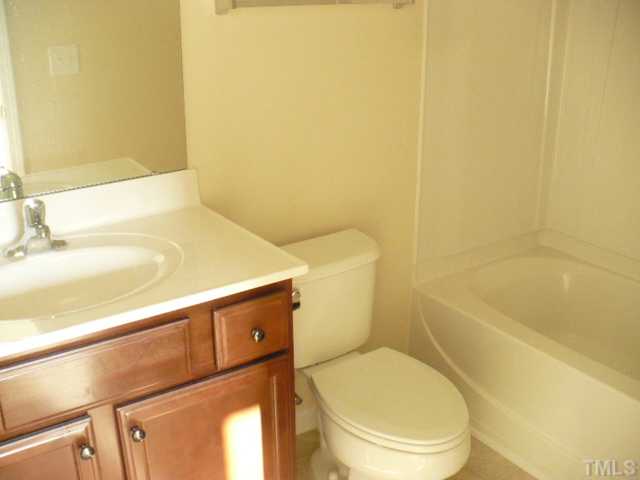 3812 Bison Hill Lane Raleigh, NC 27604 - Photo 12 of 14 a white toilet sitting next to a bathroom sink