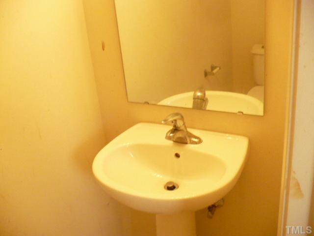 3812 Bison Hill Lane Raleigh, NC 27604 - Photo 5 of 14 a bathroom with a sink and a mirror