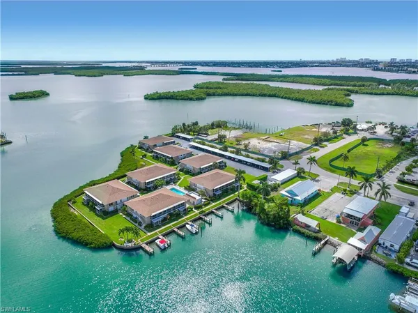 an aerial view of a house with a backyard