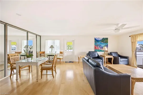 a living room with fireplace furniture and a large window