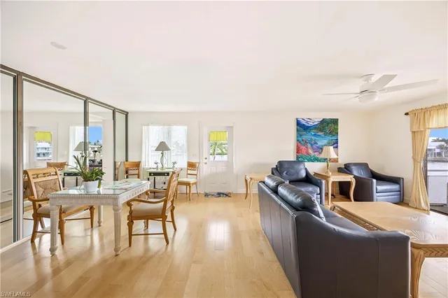 a living room with fireplace furniture and a large window
