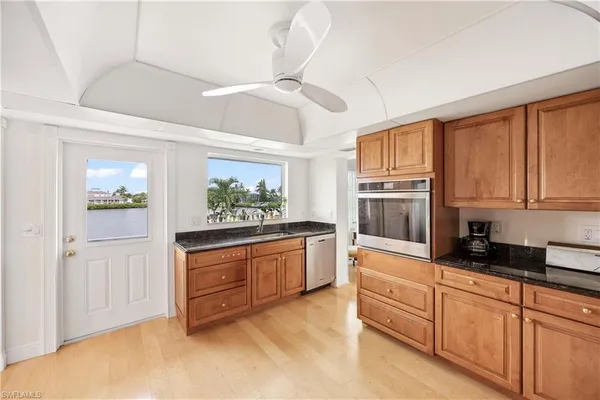 a kitchen with stainless steel appliances granite countertop a stove and cabinets