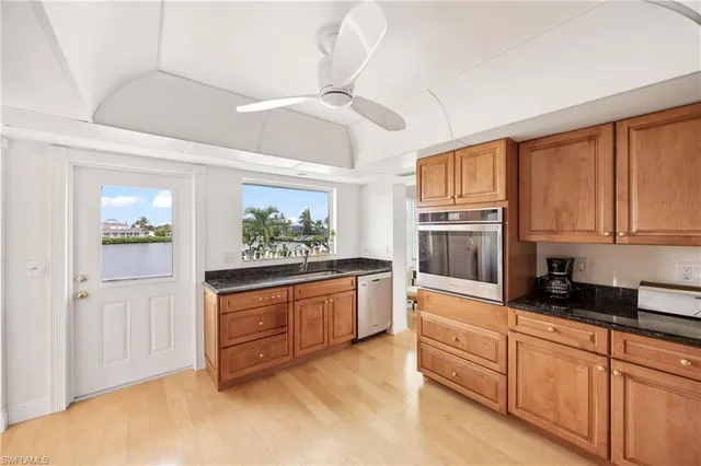 a kitchen with stainless steel appliances granite countertop a stove and cabinets