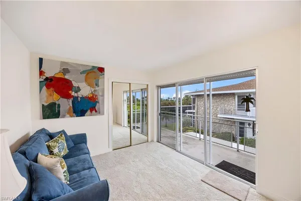 a living room with furniture and a floor to ceiling window