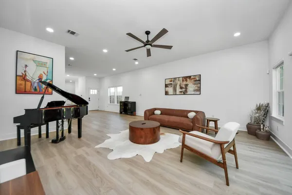 a living room with furniture and a wooden floor