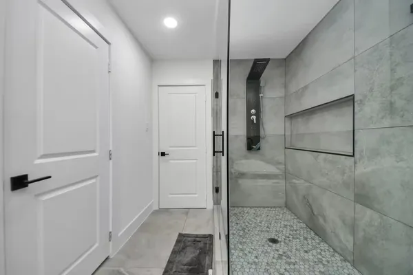 a bathroom with a shower and a glass door