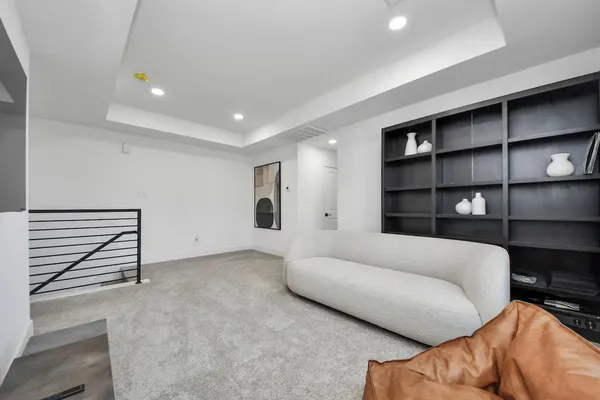 a living room with a couch and a walk in closet